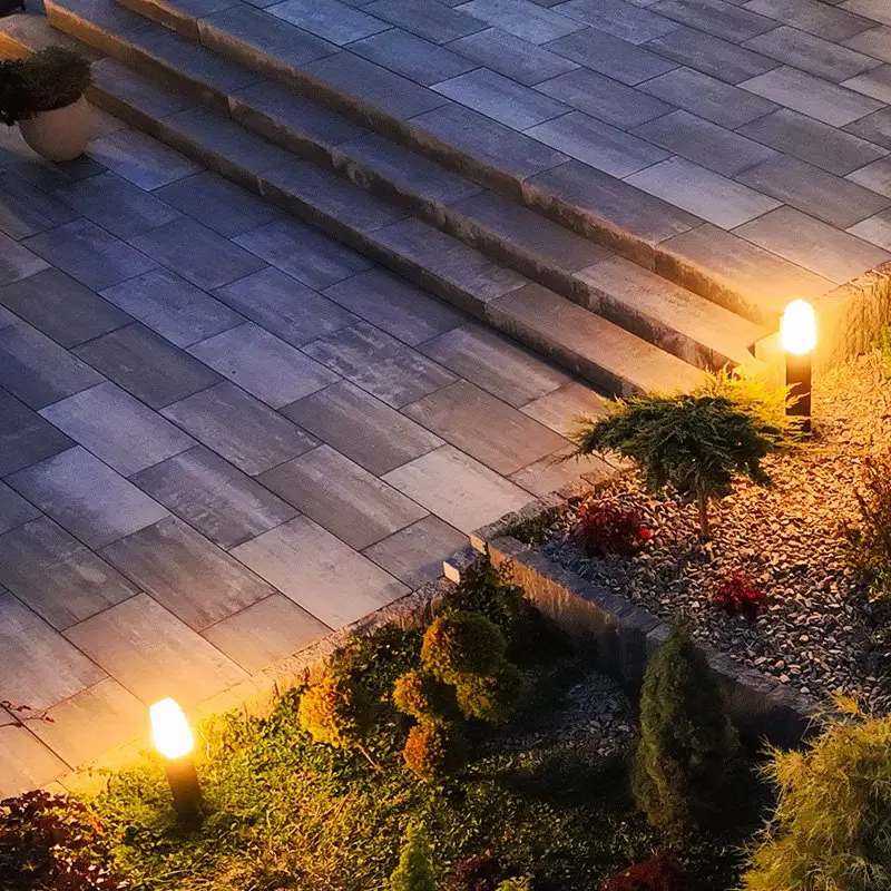 Professionally Maintained and Beautifully Arranged Backyard Garden Illuminated with Outdoor Bollard Lamps. Aerial View, Evening Time.